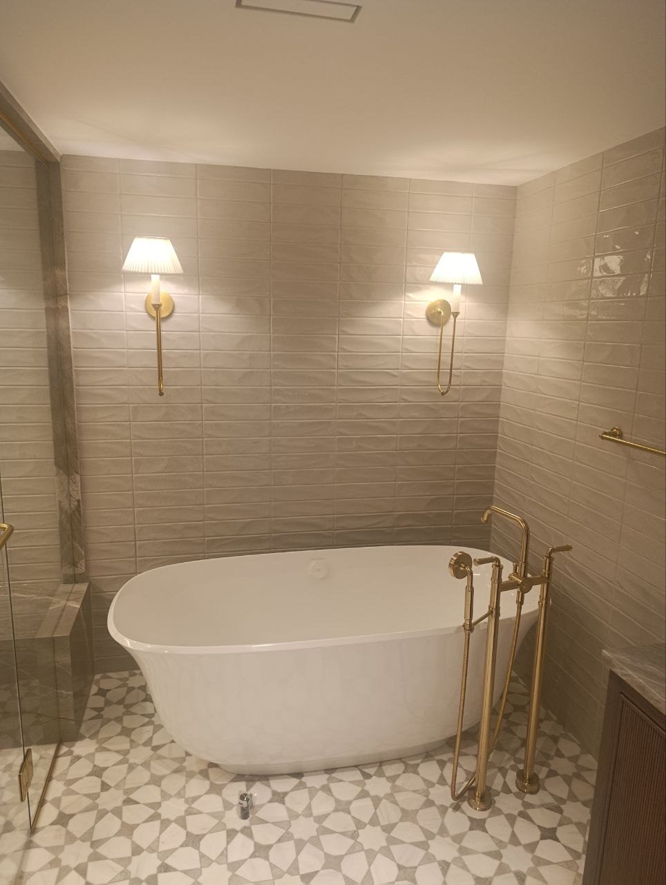 Finished ensuite by Lions Group: freestanding tub, walnut vanity, brass fixtures and patterned floor tile